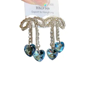 Sparkling zircon bow dangling earrings with heart-shaped blue crystal tassels for women