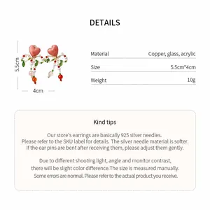 Product details of glass beaded heart bow earrings with dimensions and material info