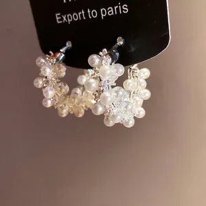 Elegant 18k gold plated hoop earrings with clustered white pearls and sparkling zirconia stones.