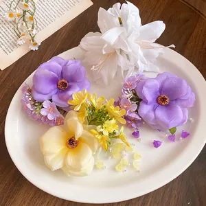 Romantic floral hair clips with pearl tassels on a white plate