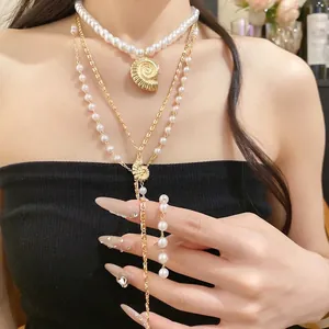 Layered conch shell and pearl pendant necklace for elegant seaside vacation style