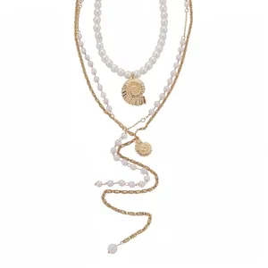 Elegant layered necklace with shell pendant and pearls, seaside vacation style jewelry.