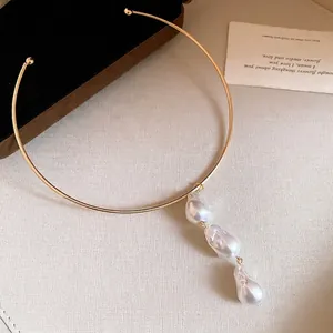 Minimalist gold metal choker necklace with three cascading baroque pearl pendants