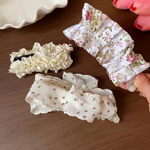 Elegant set of floral and lace fabric hair clips with pearl accents for women's hair