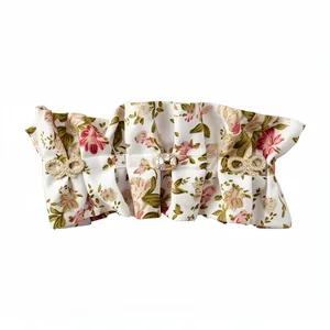 Elegant floral fabric hair clip with crystal bow and gem accents on white background