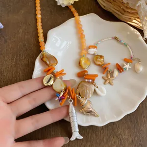 Detailansicht der Urlaubsstil-Muschelperlenkette und des Seestern-Armbands.