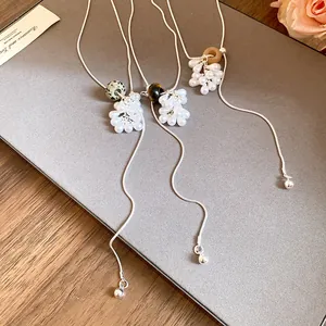 Detail of elegant water-drop pearls and stone beads on minimalist adjustable necklaces