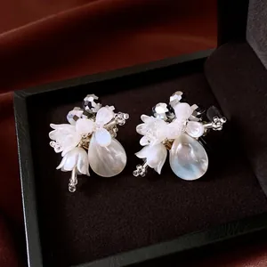 Elegant vintage crystal shell flower teardrop earrings displayed in a luxury gift box