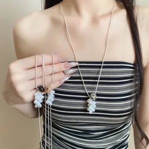 Detail view of elegant pull-through necklace with pearl drops and natural stone beads