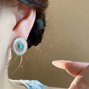 Vintage-style gold-plated oval stud earrings with mother of pearl and turquoise center