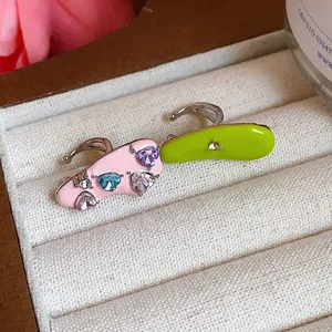 Detailed view of colorful enamel ear cuffs with sparkling heart-shaped zircon stones