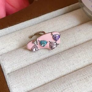 Exquisite pink enamel ear cuff featuring multi-colored heart-shaped zircon stones