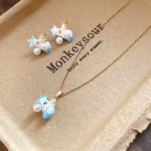 Vintage starfish jewelry set with blue enamel, pearls, and zircons on a gold chain