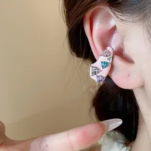 Macro view of pink enamel heart zircon ear cuff earring for non-pierced ears on a model