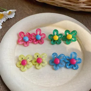 Vue détaillée de boucles d'oreilles fleurs d'été colorées aux teintes dopamine variées