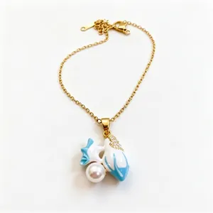 Elegant gold chain necklace with blue enamel fish pendant and white pearl detail