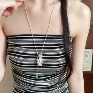 Long adjustable necklace featuring teardrop pearls and stone pendant in minimalist style