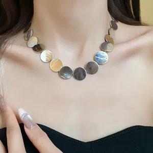 Close-up detail of a minimalist silver metal circular disc choker necklace for women