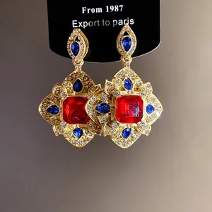Elegant vintage palace style rhombic pendant earrings featuring red and blue crystals