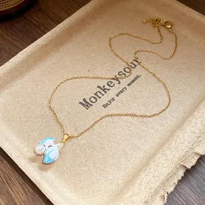 Close-up of vintage starfish pendant necklace with blue enamel and pearl on tray.