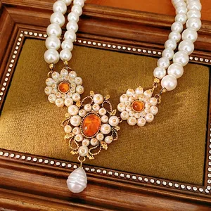 Elegant double-strand pearl necklace with vintage floral resin pendant for parties