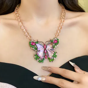 Vintage butterfly necklace with pink beads and colorful crystal rhinestones on model