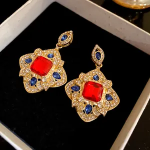 Detailed view of vintage rhombus earrings with vibrant red and blue crystal accents