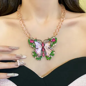 Detailed close-up of a vintage rhinestone butterfly necklace on an elegant model's neck
