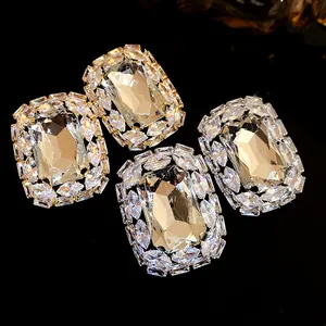 Exquisite rectangular crystal stud earrings with micro-paved rhinestones on black background