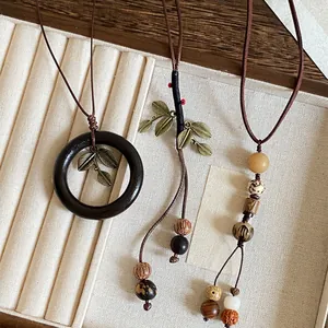 Close-up of three retro New Chinese style wooden bead long necklaces on display