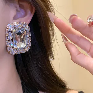 Close-up detail of luxury square stud earrings featuring sparkling crystal rhinestones
