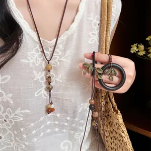 Close-up of handmade New Chinese style wooden bead necklace and retro leaf pendant jewelry