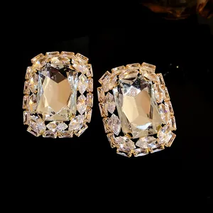 Elegant square oversized stud earrings with sparkling clear crystals in gold tone