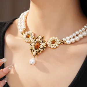 Close-up of vintage palace-style double-layered pearl necklace with amber resin stones