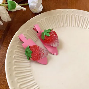Vue détaillée de deux pinces à cheveux fraise douces sur une assiette en céramique
