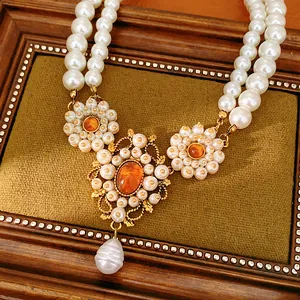 Close-up view of vintage court style double-layer pearl necklace with amber stones