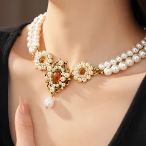 Close-up of vintage palace style double-layered pearl necklace with amber resin stones