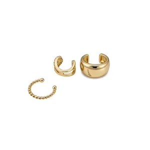 Set of three gold ear cuffs featuring twisted, smooth, and zircon-studded designs.