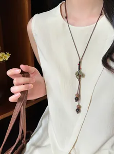 Detailed view of a retro New Chinese style wood bead long sweater necklace on a model