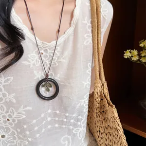 New Chinese style wooden circle necklace pendant worn with a white embroidered blouse