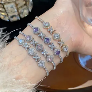 Elegant zircon rhombic flower bracelets in multiple colors worn on woman's wrist