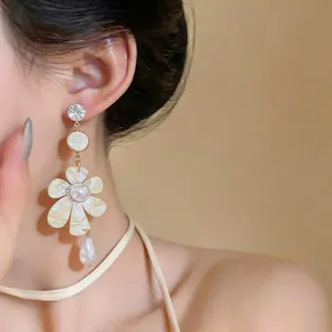 Elegant retro French style flower pearl drop earrings with silver needle on model