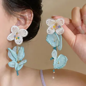 Detailed view showing the delicate lace and blue chiffon flower petals of these earrings