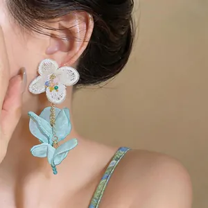 Elegant chiffon flower tassel earrings featuring white lace and blue fabric petals