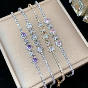 Detailed view of four elegant French style zircon flower bracelets in silver and gold
