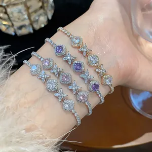 Detailed macro view of delicate French-style zirconia flower bracelets on a wrist