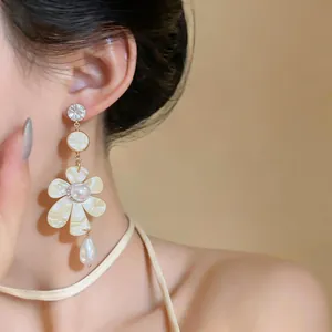Macro view of vintage French floral drop earring with pearls and sparkling crystals