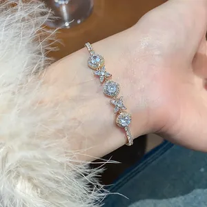 Close-up of French style gold flower bracelet with sparkling cubic zirconia on wrist