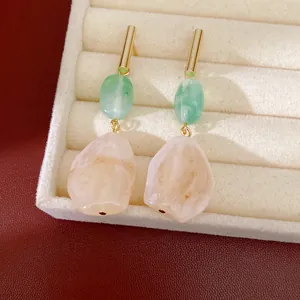 Primer plano de pendientes vintage de resina con patrón de mármol en un estuche