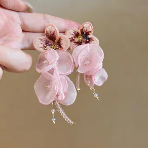 Detailed view of pink chiffon flower tassel earrings with delicate embroidery and beads.